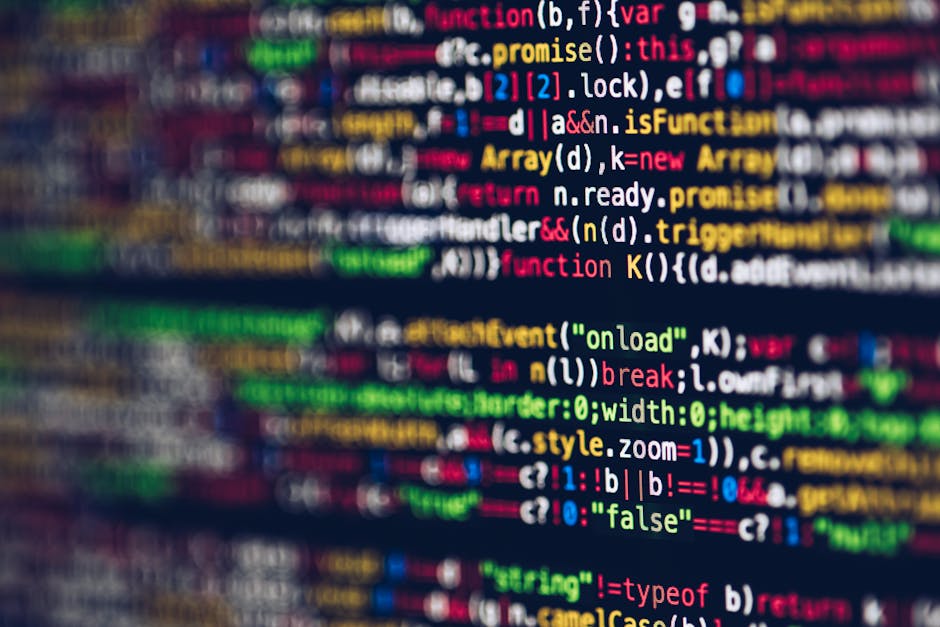 A close-up photograph of a computer screen displaying colorful lines of code in various programming languages. The code includes keywords, functions, variables, and syntax highlighted in colors such a